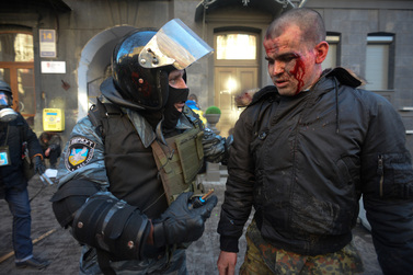 Ukrainian berkut militiaman talks to a protester